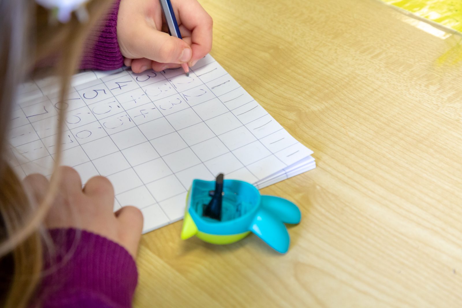 child writing numbers